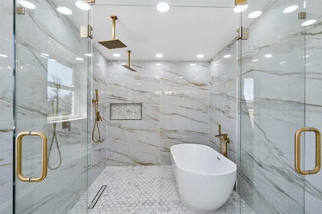 bathroom featuring a freestanding tub, recessed lighting, a marble finish shower, tile walls, and tile patterned flooring