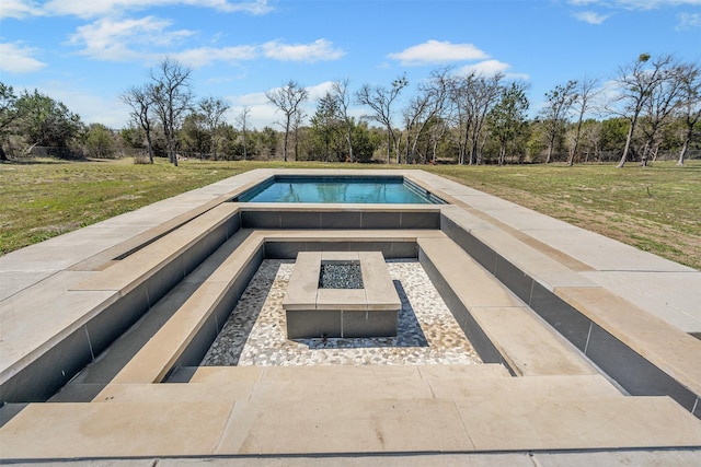 pool featuring a lawn and an outdoor fire pit