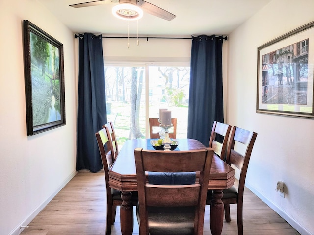 dining room with ceiling fan, baseboards, and light wood-style floors