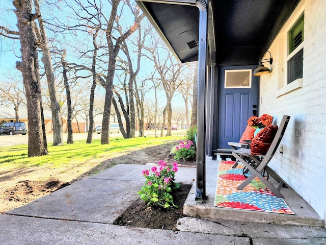 view of exterior entry featuring visible vents and concrete block siding