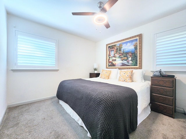 carpeted bedroom with baseboards and ceiling fan