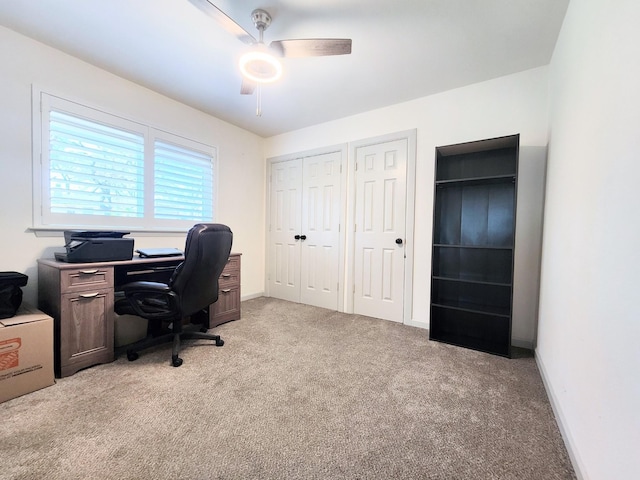 office with light colored carpet, baseboards, and ceiling fan