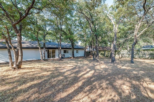 ranch-style home with fence and a garage