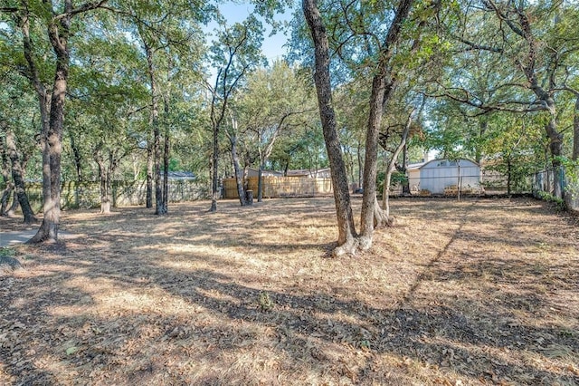 view of yard with an outbuilding and fence