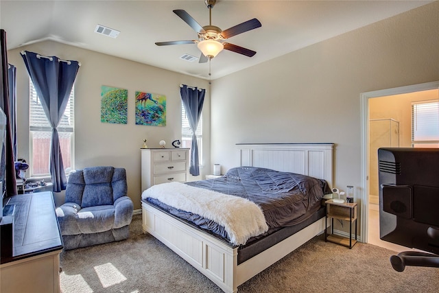 carpeted bedroom featuring vaulted ceiling, a ceiling fan, and visible vents