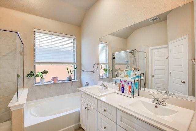 full bathroom with a sink, visible vents, a garden tub, and a shower stall