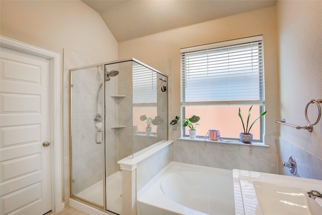 bathroom featuring a shower stall and a bath