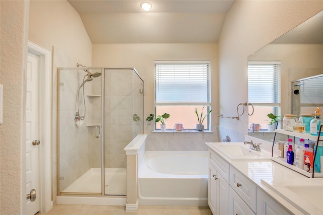 full bathroom featuring a sink, a healthy amount of sunlight, a stall shower, and vaulted ceiling