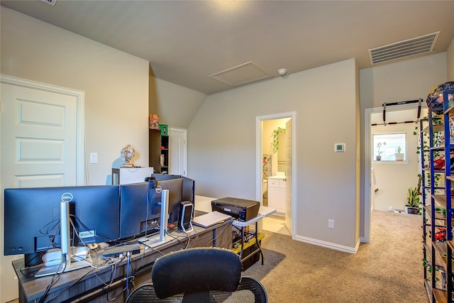 carpeted office with attic access, baseboards, visible vents, and lofted ceiling