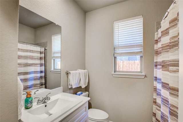 full bath with a shower with shower curtain, toilet, vanity, and a textured wall