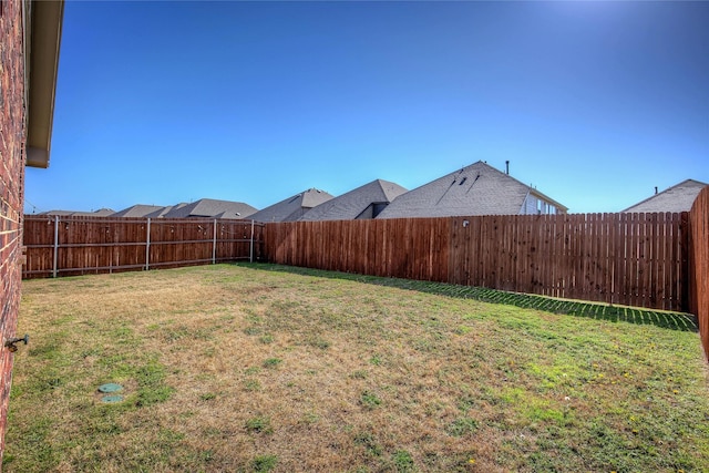 view of yard with a fenced backyard