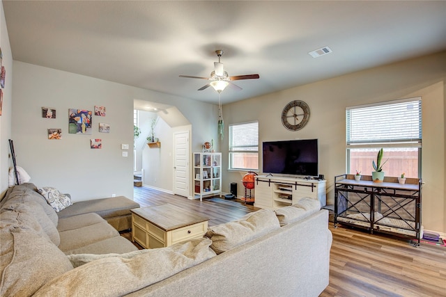 living area with visible vents, a healthy amount of sunlight, ceiling fan, and wood finished floors