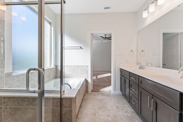 full bathroom featuring a sink, visible vents, a garden tub, and double vanity