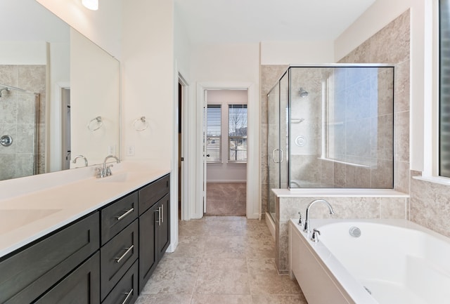 full bath with double vanity, a shower stall, a garden tub, and a sink