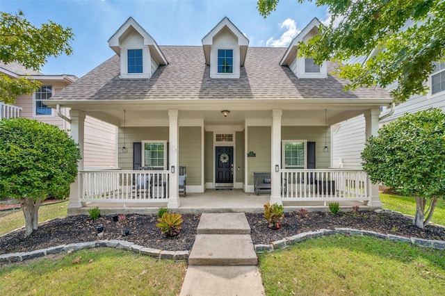 view of front of house with roof with shingles and a porch