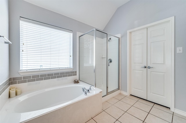 full bathroom with tile patterned flooring, a shower stall, a bath, and vaulted ceiling