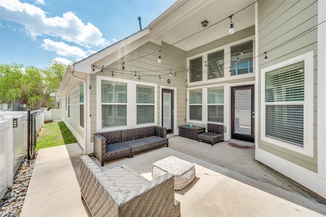 view of patio with an outdoor living space and fence