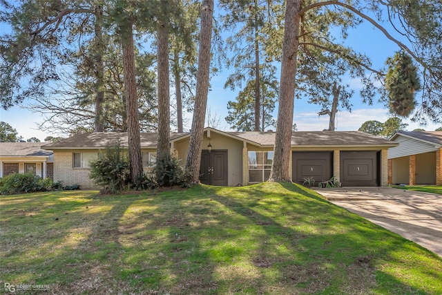 ranch-style home featuring a front yard, an attached garage, brick siding, and driveway