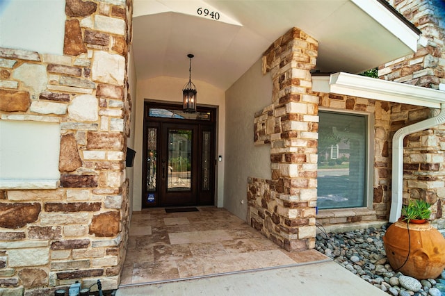 doorway to property featuring stone siding