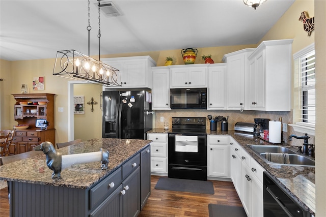 kitchen featuring black appliances, a sink, backsplash, white cabinets, and dark wood-style flooring