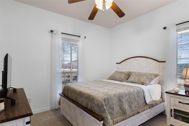 bedroom featuring baseboards, carpet floors, and a ceiling fan