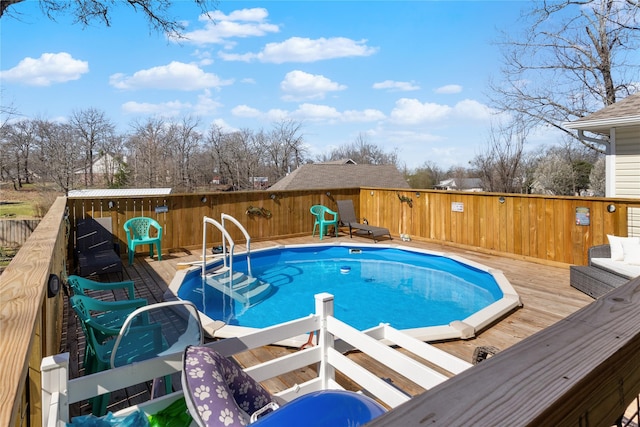 view of pool featuring a deck and a fenced in pool