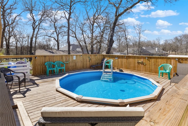 view of swimming pool featuring a deck