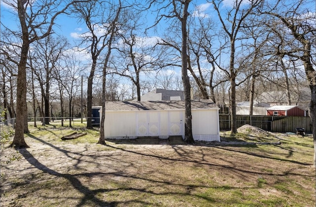 view of yard with an outdoor structure and fence