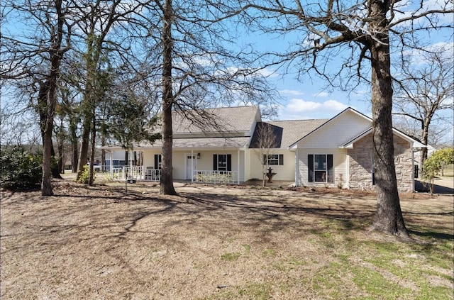 ranch-style house featuring stone siding and covered porch