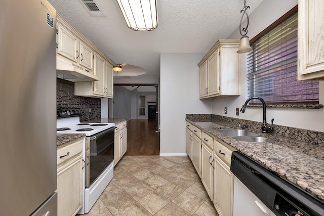 kitchen featuring under cabinet range hood, dishwasher, freestanding refrigerator, electric range, and a sink