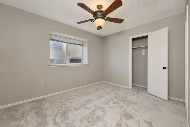 unfurnished bedroom with baseboards, carpet floors, a textured ceiling, and a ceiling fan