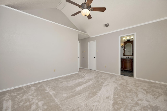 unfurnished bedroom featuring baseboards, visible vents, lofted ceiling, carpet flooring, and connected bathroom