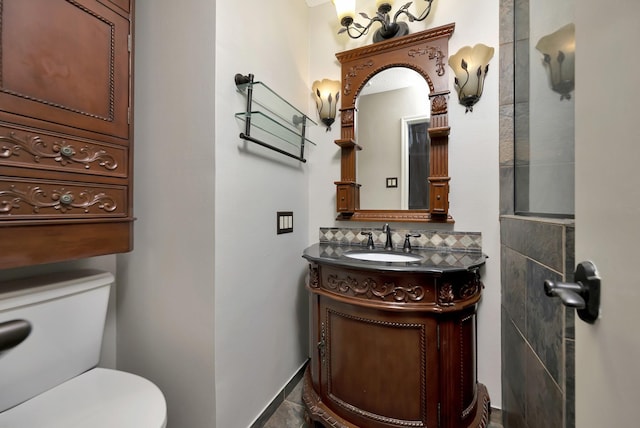 bathroom with decorative backsplash, toilet, and vanity