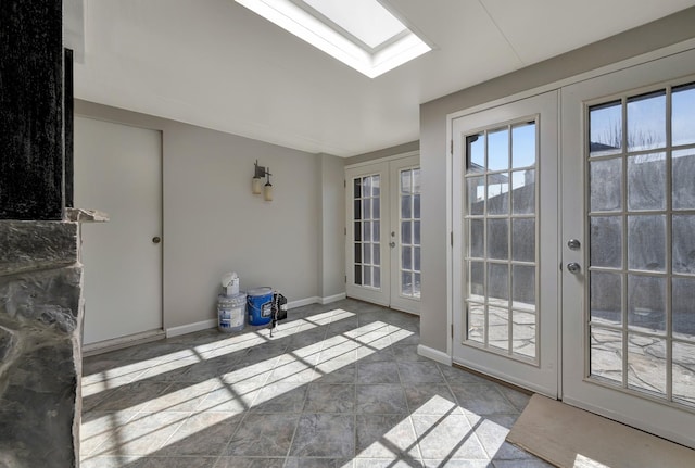 unfurnished sunroom with a healthy amount of sunlight, french doors, and a skylight