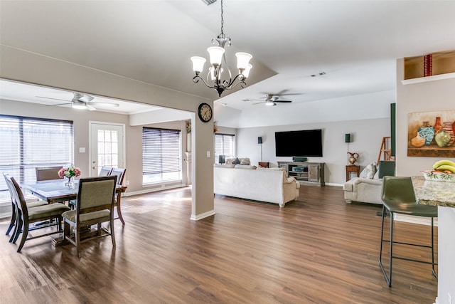 dining space with baseboards, dark wood-style floors, and ceiling fan with notable chandelier