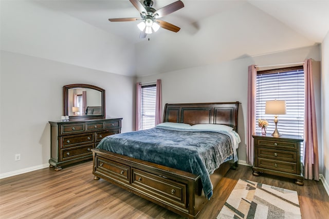 bedroom featuring ceiling fan, baseboards, lofted ceiling, and wood finished floors