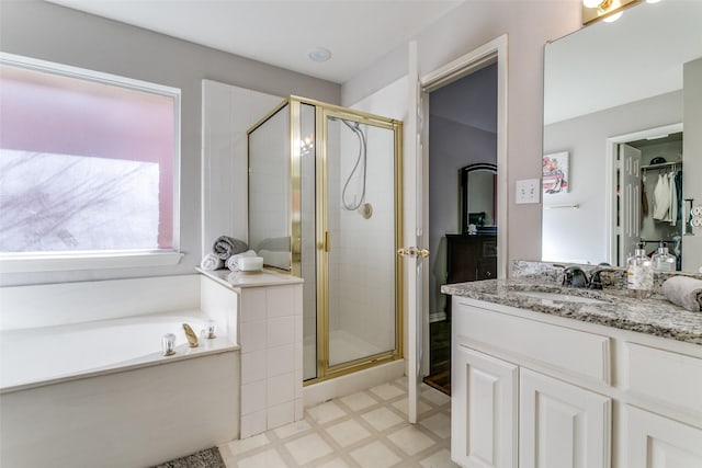 bathroom with vanity, tile patterned floors, a garden tub, and a stall shower