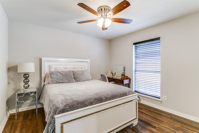 bedroom with a ceiling fan, baseboards, and wood finished floors