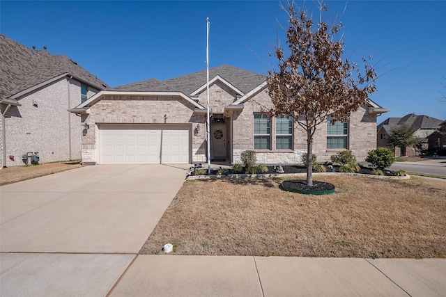 ranch-style house with a front yard, brick siding, concrete driveway, and an attached garage