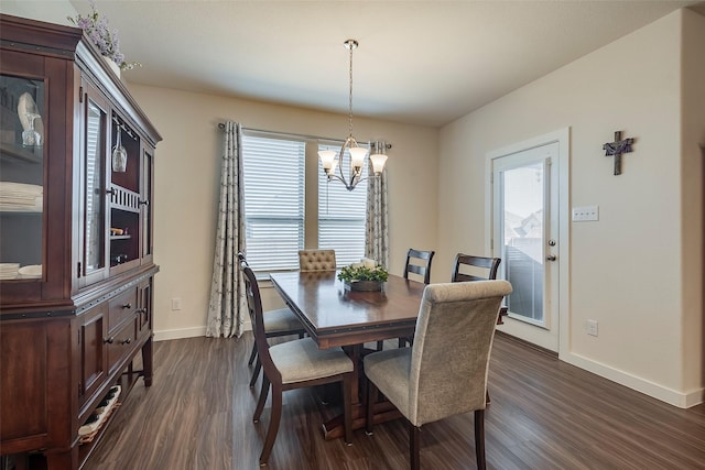 dining area with dark wood finished floors, baseboards, and a chandelier