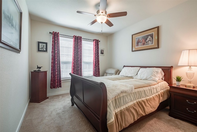 bedroom with light carpet, ceiling fan, and baseboards