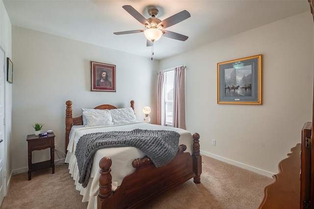 bedroom with a ceiling fan, light colored carpet, and baseboards