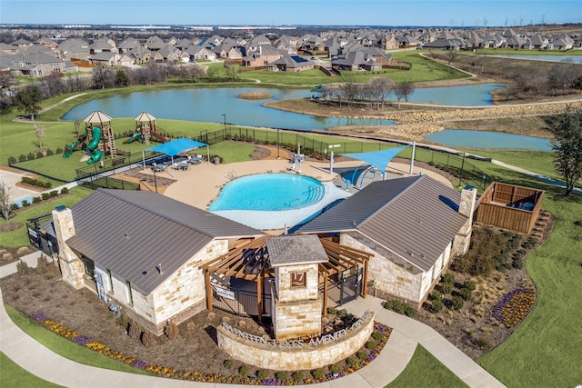 drone / aerial view featuring a residential view and a water view