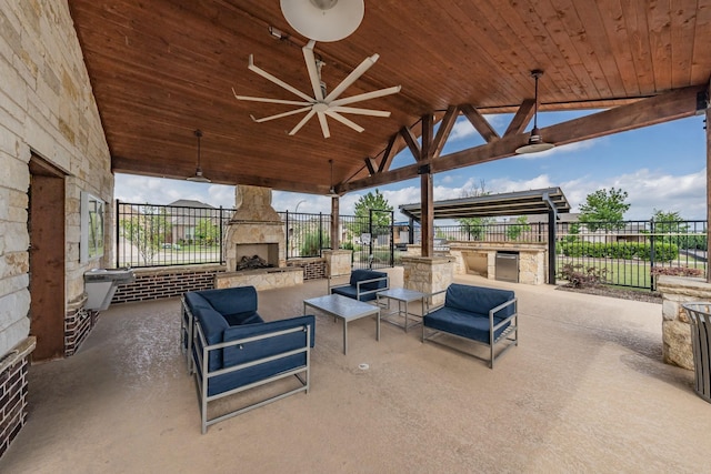 view of patio / terrace with a gazebo, an outdoor living space with a fireplace, ceiling fan, and fence