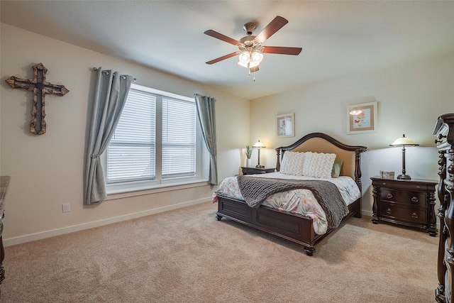 carpeted bedroom with baseboards and a ceiling fan