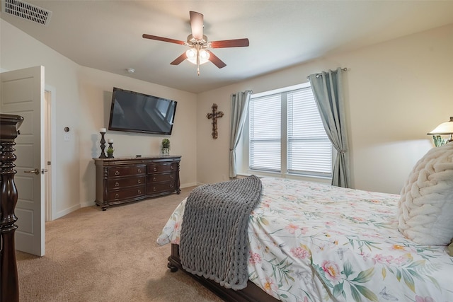 bedroom featuring baseboards, a ceiling fan, visible vents, and light carpet