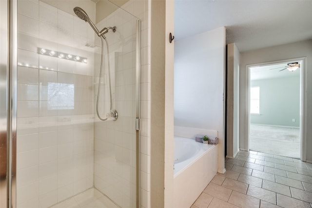 full bathroom featuring a bath and a shower stall