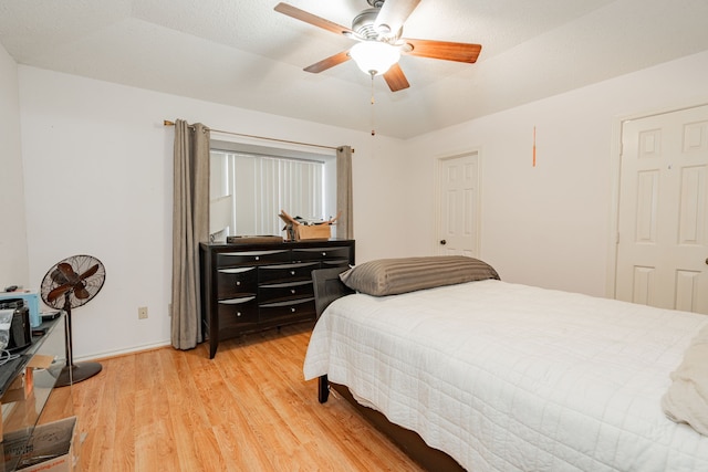 bedroom with light wood-type flooring and ceiling fan