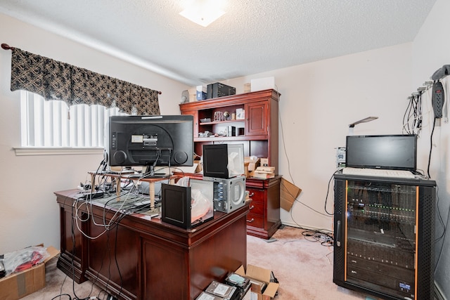 office area with a textured ceiling and light carpet