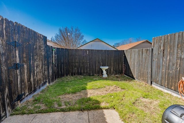 view of yard with a fenced backyard